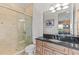 Well-lit bathroom with a glass shower door, vanity with a dark countertop, and ceramic tile at 3700 Como St, Port Charlotte, FL 33948