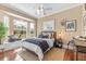 Comfortable bedroom featuring a bay window with scenic backyard views and modern decor at 3700 Como St, Port Charlotte, FL 33948