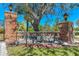 Beautiful brick Ridge Brook Shores entrance sign with mature trees and manicured landscaping on a sunny day at 3700 Como St, Port Charlotte, FL 33948