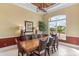 Formal dining room boasts a large window with view and stylish décor, ideal for gatherings at 3700 Como St, Port Charlotte, FL 33948
