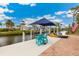 Dock with boat lift, blue sun umbrella, seating, and direct access to canal at 3700 Como St, Port Charlotte, FL 33948