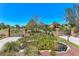 Grand entrance gate with brick pillars, wrought iron gates, and a serene pond surrounded by lush greenery at 3700 Como St, Port Charlotte, FL 33948