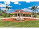 Grand exterior with circular driveway, fountain, mature palms, and manicured lawn at 3700 Como St, Port Charlotte, FL 33948