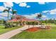 Stunning two-story home featuring lush landscaping, a fountain, and a brick driveway at 3700 Como St, Port Charlotte, FL 33948