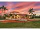 Beautiful home boasting a circular driveway, three-car garage, and mature palm trees at 3700 Como St, Port Charlotte, FL 33948