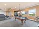 Spacious game room with pool table, recessed lighting, windows with a view and direct access to the theatre room at 3700 Como St, Port Charlotte, FL 33948