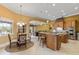 Gourmet kitchen with granite countertops, custom wood island, and stainless steel appliances is open to the dining area at 3700 Como St, Port Charlotte, FL 33948
