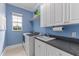 Laundry room with sink, washer, dryer, and storage cabinets at 3700 Como St, Port Charlotte, FL 33948
