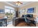 Home office with a large window, desk, and built-in shelving at 3700 Como St, Port Charlotte, FL 33948