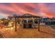 Outdoor bar with seating, fire pit, and water access overlooking the sunset at 3700 Como St, Port Charlotte, FL 33948