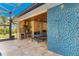 Spacious outdoor living area with a pool, outdoor kitchen, ping pong table, and shower provides entertainment at 3700 Como St, Port Charlotte, FL 33948