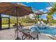 Enjoy this screened in pool with a connected jacuzzi and beautiful patio furniture at 3700 Como St, Port Charlotte, FL 33948
