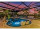 This beautiful pool has a jacuzzi, sun chairs in the water, and a screened-in patio for added privacy at 3700 Como St, Port Charlotte, FL 33948