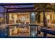 Covered outdoor kitchen and a pool with lounge chairs offer an ideal relaxation space at 3700 Como St, Port Charlotte, FL 33948