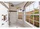 Luxurious walk-in shower with dual shower heads and a window with tropical views at 3700 Como St, Port Charlotte, FL 33948