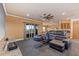 Spacious theater room with tiered seating, a ceiling fan, a small kitchenette, and access to the balcony at 3700 Como St, Port Charlotte, FL 33948