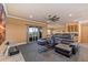 Spacious theater room with tiered seating, a ceiling fan, a small kitchenette, and access to the balcony at 3700 Como St, Port Charlotte, FL 33948