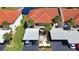 Aerial view of the buildings, carports, and palm trees with cars parked under the carports at 405 Pine Hollow Cir # 405, Englewood, FL 34223