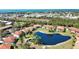 Breathtaking aerial view of condo community surrounding a pond, and beautiful nature in the background at 405 Pine Hollow Cir # 405, Englewood, FL 34223