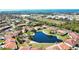 An aerial view of a condo complex surrounding a pond, showcasing a coastal community at 405 Pine Hollow Cir # 405, Englewood, FL 34223