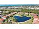 Scenic aerial view of condo community surrounding a pond, lush landscaping, and a glimpse of the Gulf of Mexico at 405 Pine Hollow Cir # 405, Englewood, FL 34223