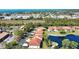 Overhead view of condo community with lake and lush foliage, carports and well-maintained landscaping at 405 Pine Hollow Cir # 405, Englewood, FL 34223