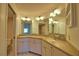 Bathroom featuring dual sinks, ample counter space, and abundant lighting at 405 Pine Hollow Cir # 405, Englewood, FL 34223