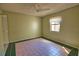 A clean and well-lit bedroom with tile flooring and a ceiling fan, offering a blank canvas at 405 Pine Hollow Cir # 405, Englewood, FL 34223