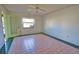 Bright bedroom with tiled flooring, ceiling fan and outdoor views at 405 Pine Hollow Cir # 405, Englewood, FL 34223