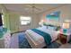 Comfortable bedroom featuring a queen bed, blue accents, and ample natural light at 405 Pine Hollow Cir # 405, Englewood, FL 34223