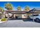 Exterior carport parking spaces with nearby landscaping and a white vehicle at 405 Pine Hollow Cir # 405, Englewood, FL 34223