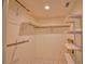 Well-organized walk-in closet with multiple shelves and hanging rods for ample storage at 405 Pine Hollow Cir # 405, Englewood, FL 34223