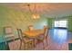 Dining room with tiled floors and a modern light fixture, offering a spacious area for Gathering gatherings at 405 Pine Hollow Cir # 405, Englewood, FL 34223