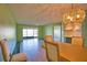 Open-concept dining room with ample light and tiled floors, seamlessly connecting to the living space at 405 Pine Hollow Cir # 405, Englewood, FL 34223