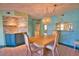 A charming dining room features a table with seating for four and custom lighting at 405 Pine Hollow Cir # 405, Englewood, FL 34223