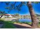 Scenic view of the exterior buildings next to a pond under a blue sky surrounded by trees at 405 Pine Hollow Cir # 405, Englewood, FL 34223