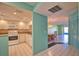 Bright kitchen features white appliances and cabinetry, and a dining area with a decorative light fixture at 405 Pine Hollow Cir # 405, Englewood, FL 34223