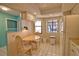 Bright eat-in kitchen with white cabinets, natural light, and tiled floors, plus a small dining table at 405 Pine Hollow Cir # 405, Englewood, FL 34223