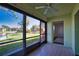 Comfortable screened lanai with a tranquil view of the community pond and common area at 405 Pine Hollow Cir # 405, Englewood, FL 34223