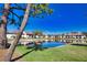 Scenic view of community buildings reflected in a tranquil pond on a bright day at 405 Pine Hollow Cir # 405, Englewood, FL 34223