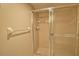 Enclosed shower with glass doors and tile surround at 405 Pine Hollow Cir # 405, Englewood, FL 34223