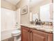 A second bathroom featuring a shower-tub combo, granite countertop, and ample lighting at 4238 Golfair Ln, North Port, FL 34288