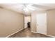 This bedroom features a ceiling fan, tile flooring, and two separate doors at 4238 Golfair Ln, North Port, FL 34288