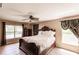 Spacious bedroom featuring a decorative fan, tile floors and well-lit windows at 4238 Golfair Ln, North Port, FL 34288