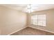 A bedroom with neutral walls, tiled floor, and a window with blinds at 4238 Golfair Ln, North Port, FL 34288