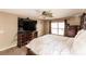 Comfortable bedroom features a ceiling fan, TV, and a chest of drawers at 4238 Golfair Ln, North Port, FL 34288
