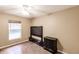 This simple bedroom features dark furniture and a window overlooking a pool at 4238 Golfair Ln, North Port, FL 34288