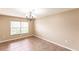 Light-filled dining room with a chandelier and a large window at 4238 Golfair Ln, North Port, FL 34288