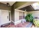 Charming front porch with brick pavers, a bench, and lush greenery at 4238 Golfair Ln, North Port, FL 34288