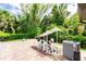 Outdoor equipment area with AC unit and pool pump on a brick surface with tropical greenery at 4238 Golfair Ln, North Port, FL 34288